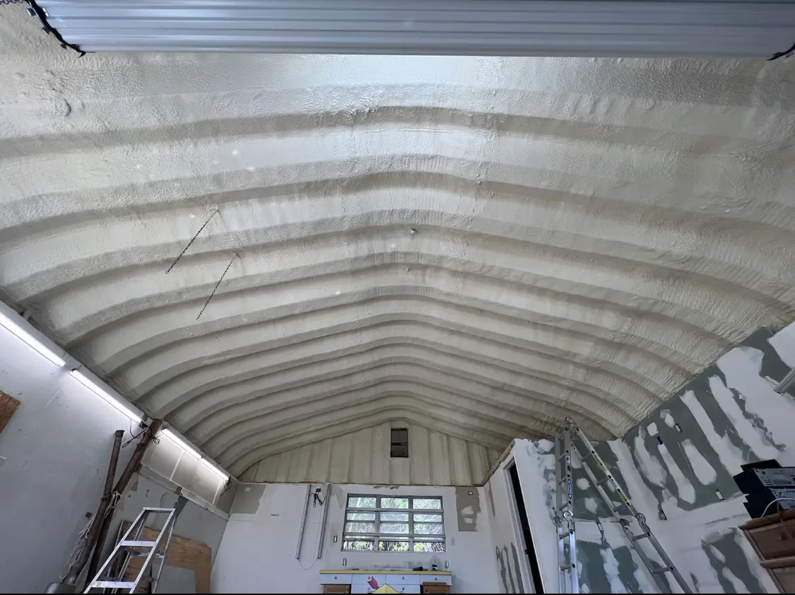 Spray polyurethane foam applied to the underside of a metal roof deck in Morris